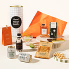Australian-themed gift hamper containing Four Pillars gin, 2 cans of Strangelove coastal tonic, Lemon myrtle syrup, saltbush dukkah, macadamias and a macadamia milk chocolate. Packaged in a fun canister.