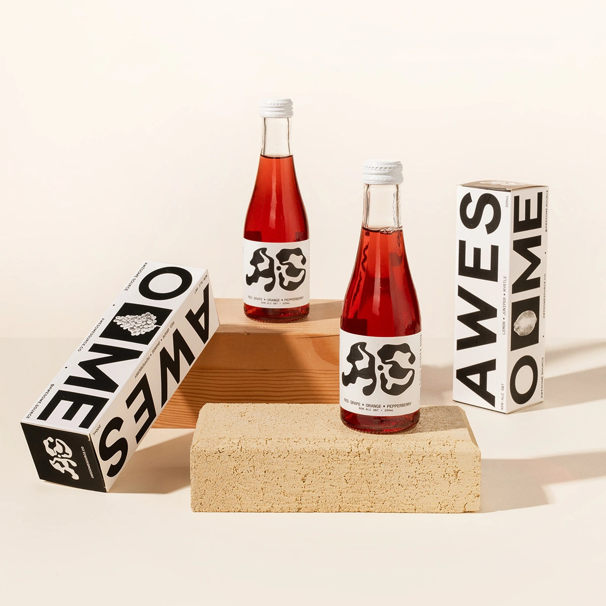 Two bottles of red grape, orange & pepperberry non-alcoholic drink.