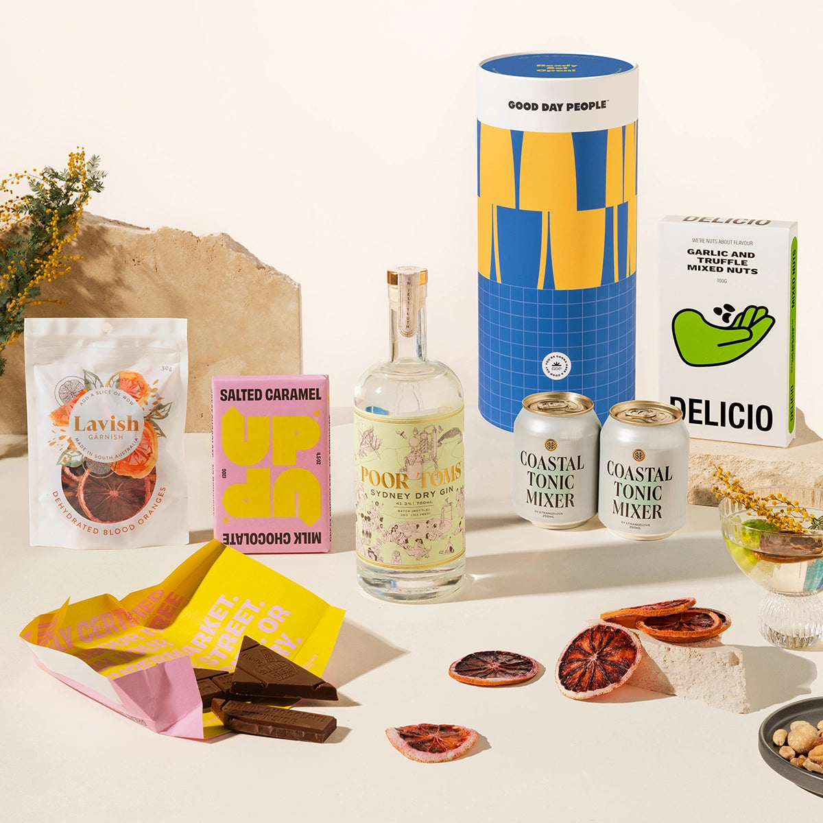 Gin Gift hamper with Poor Toms Sydney Dry Gin, 2 cans of Strangelove coastal tonic mixers, Up-Up chocolate, Lavish blood orange garnishes and Delicio garlic & truffle mixed nuts. Packaged in a fun gift canister.
