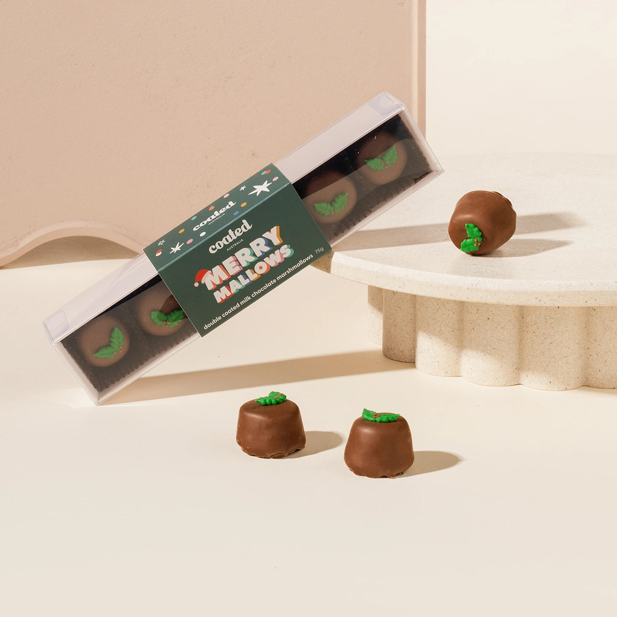 Merry Mallows chocolate treats with a box on a beige background