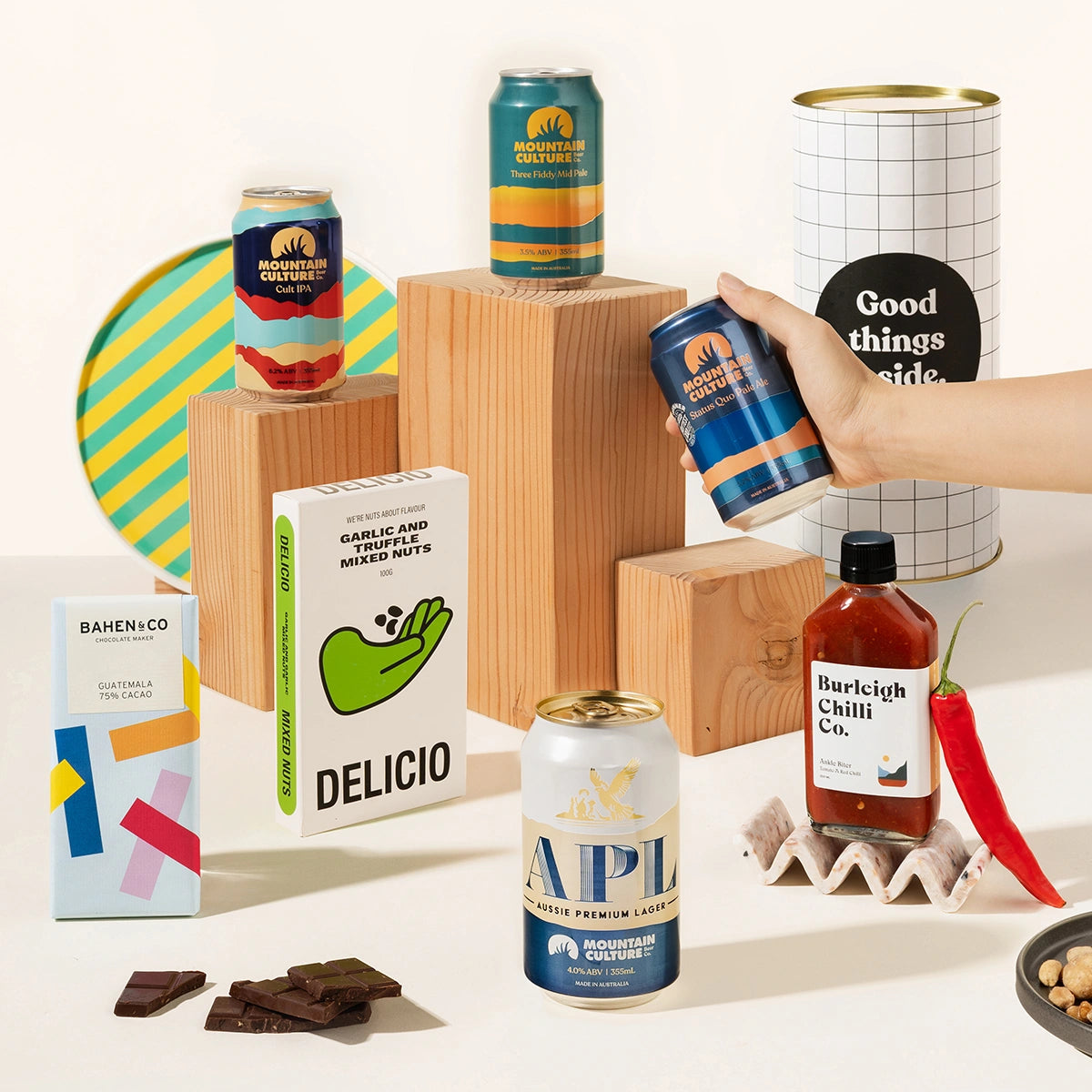 Craft beer gift hamper with 4 cans of Mountain Culture beer, burleigh chilli sauce, Garlic & truffle mixed nuts and organic chocolate. Packaged in a cool canister.