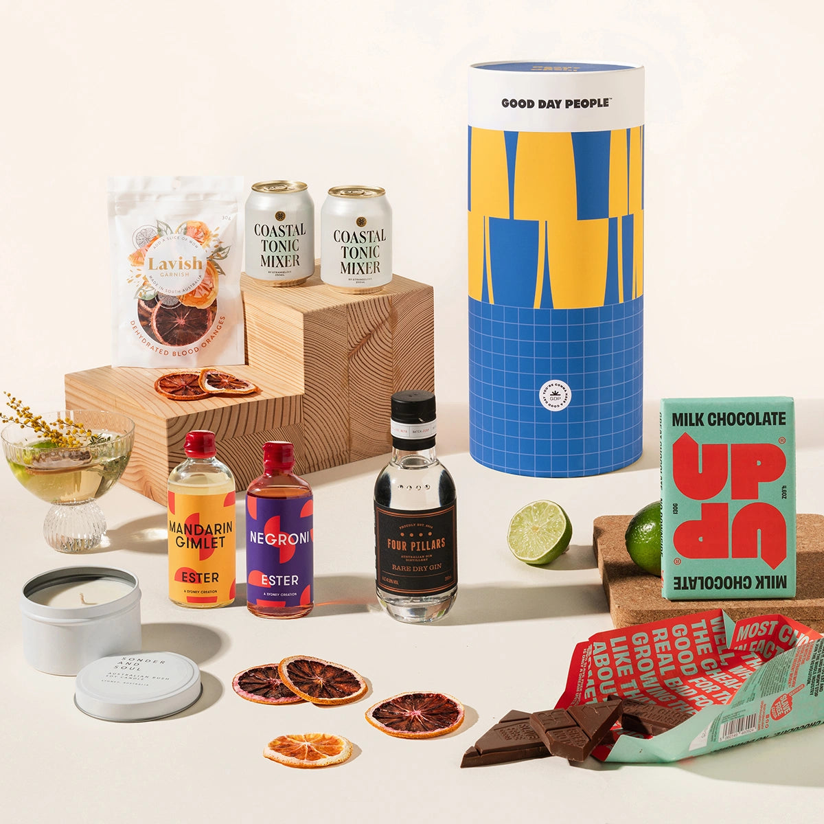 Gin & tonic gift hamper with Four Pillars gin, 2 cans of coastal tonic mixers, Lavish blood orange garnish, a tinned candle, and Up-Up chocolate. Packaged in a designed canister.
