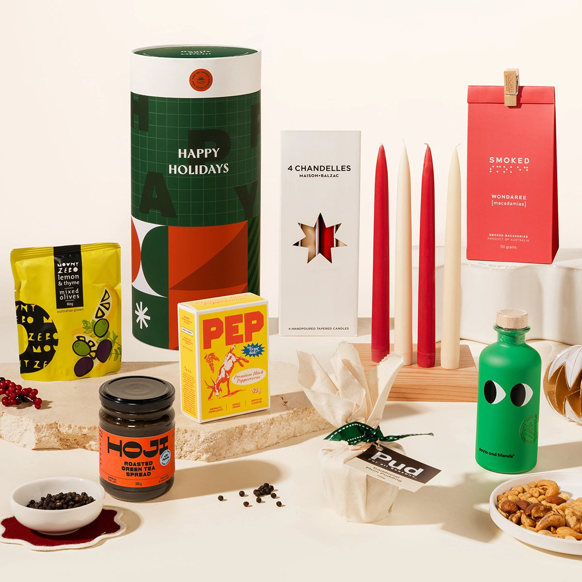 Luxurious Christmas Hamper with 4 tapered candles, nuts, hojicha spread, greek olive oil, christmas pudding, gourmet pepper & mount zero olives. Packaged in an epic, designed canister. Trendy & Bougie Christmas gift.