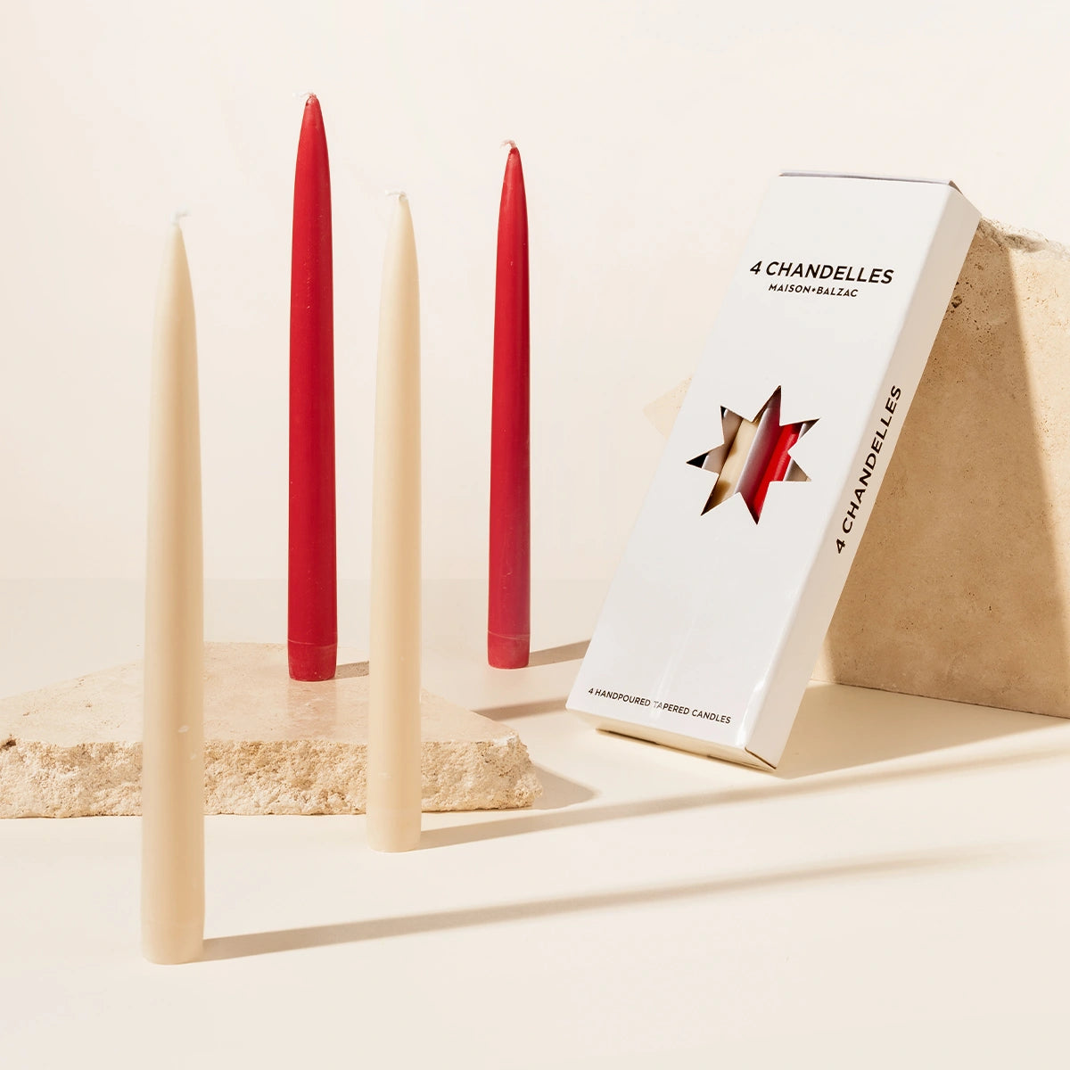 Maison Balzac set of 4 red and beige candles with a '4 Chandeliers' box on a neutral background
