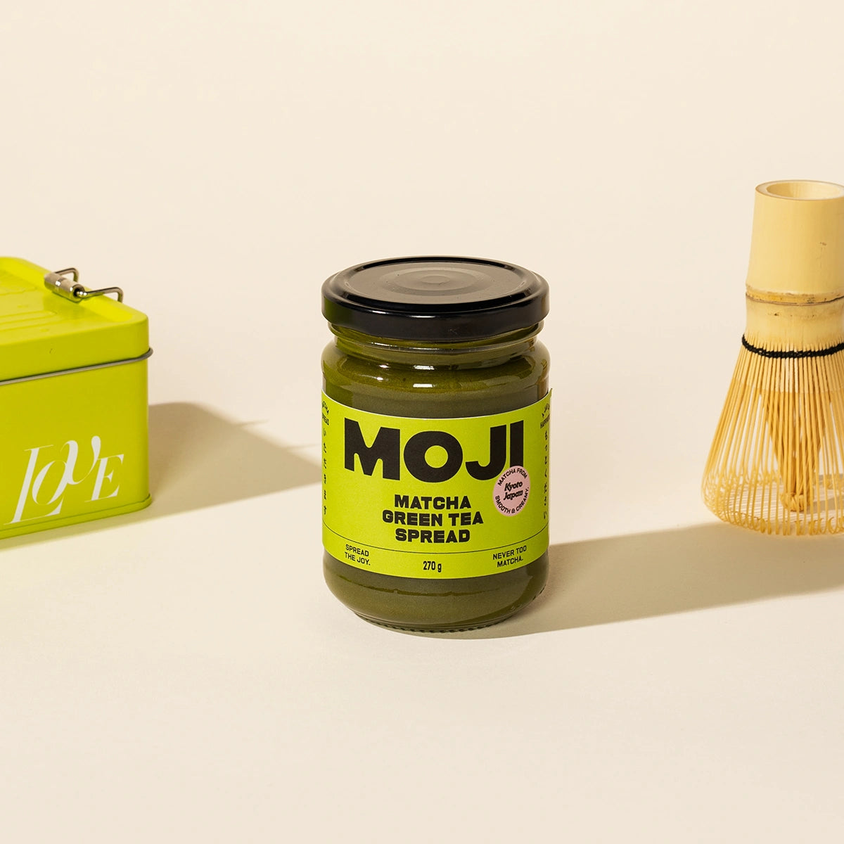 Jar of MOJI Matcha Green Tea Spread with a green label on a beige background