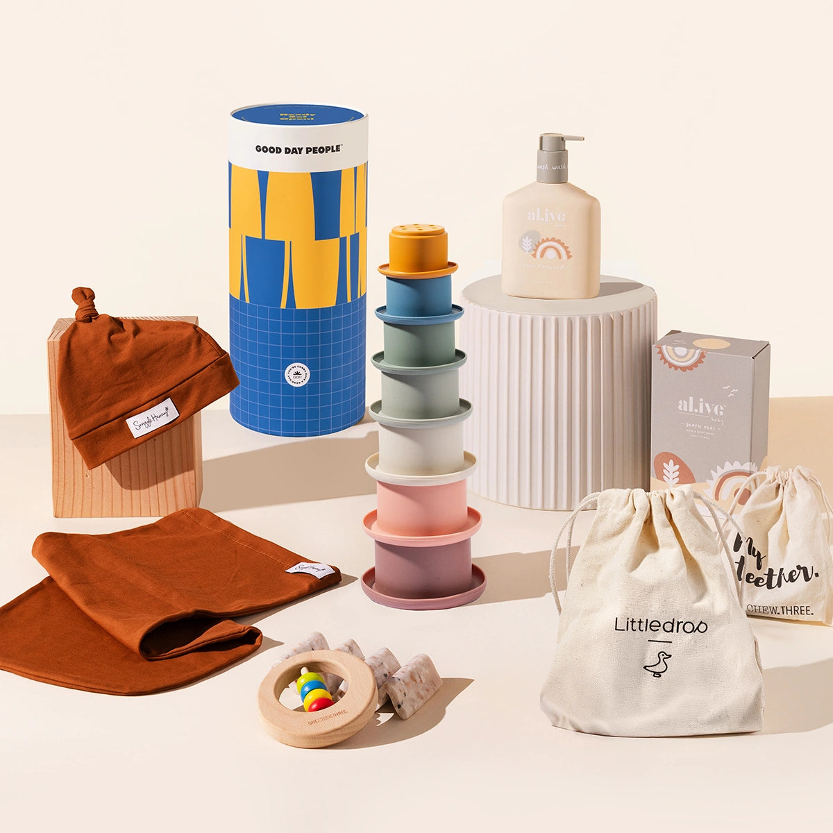 Baby gift hamper with stacking toys, Al.ive body wash, teether, and swaddle set with beanine