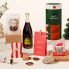 Christmas gift hamper with sangria spritz, blood orange garnishes, macadamias, chocolate and fairy floss. Delivered in a fun, luxe, designed canister.