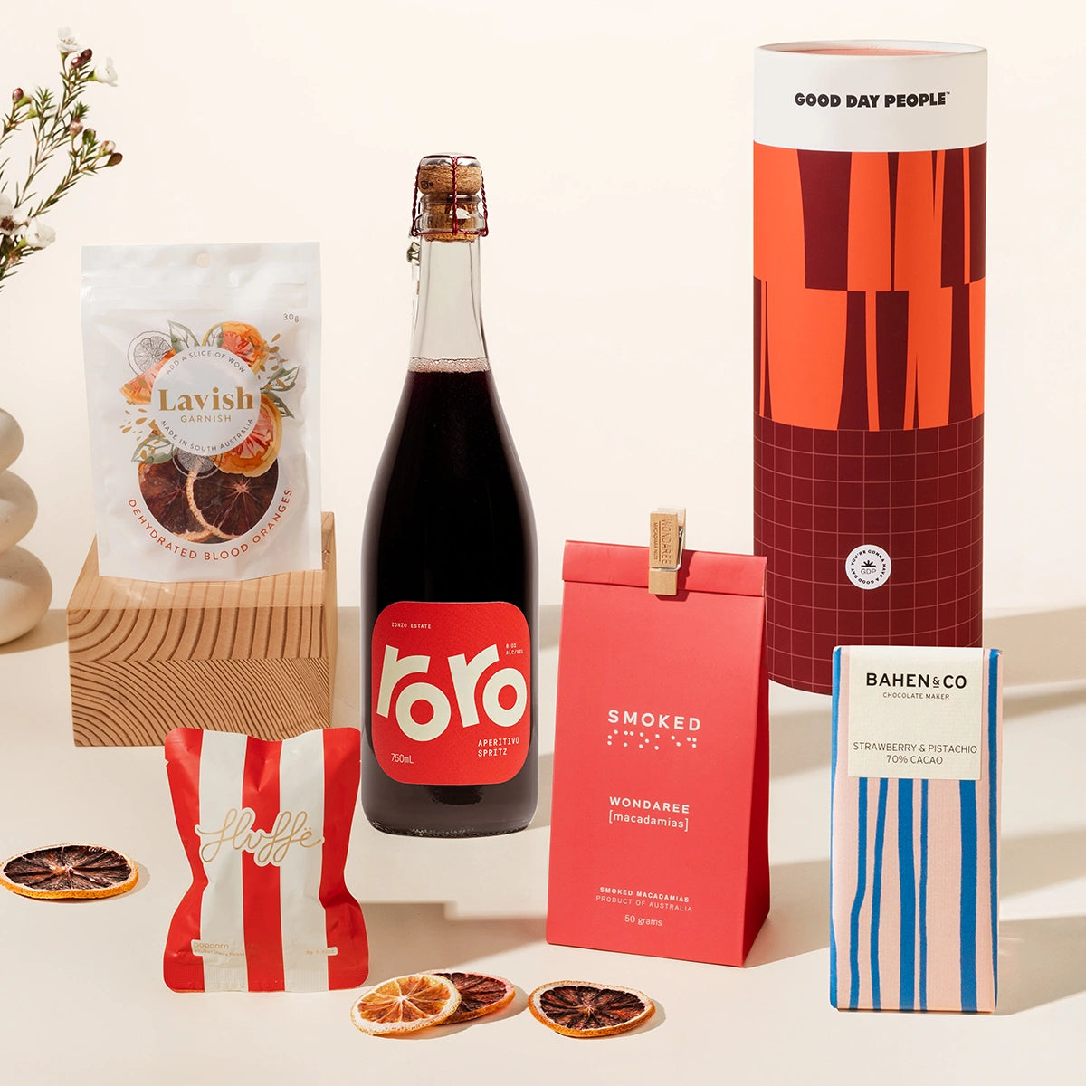 A spritzy gift hamper with Zonzo's Roro Aperitivo Spritz, macadamias, chocolate, fancy fairy floss and blood orange garnishes. Packaged in a designed canister for an extra bougie unboxing experience.
