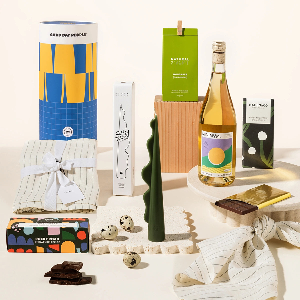 Tasteful Tim gift hamper with linen napkins, sculptural candle, wondaree macadamias, rocky road, wine and chocolate