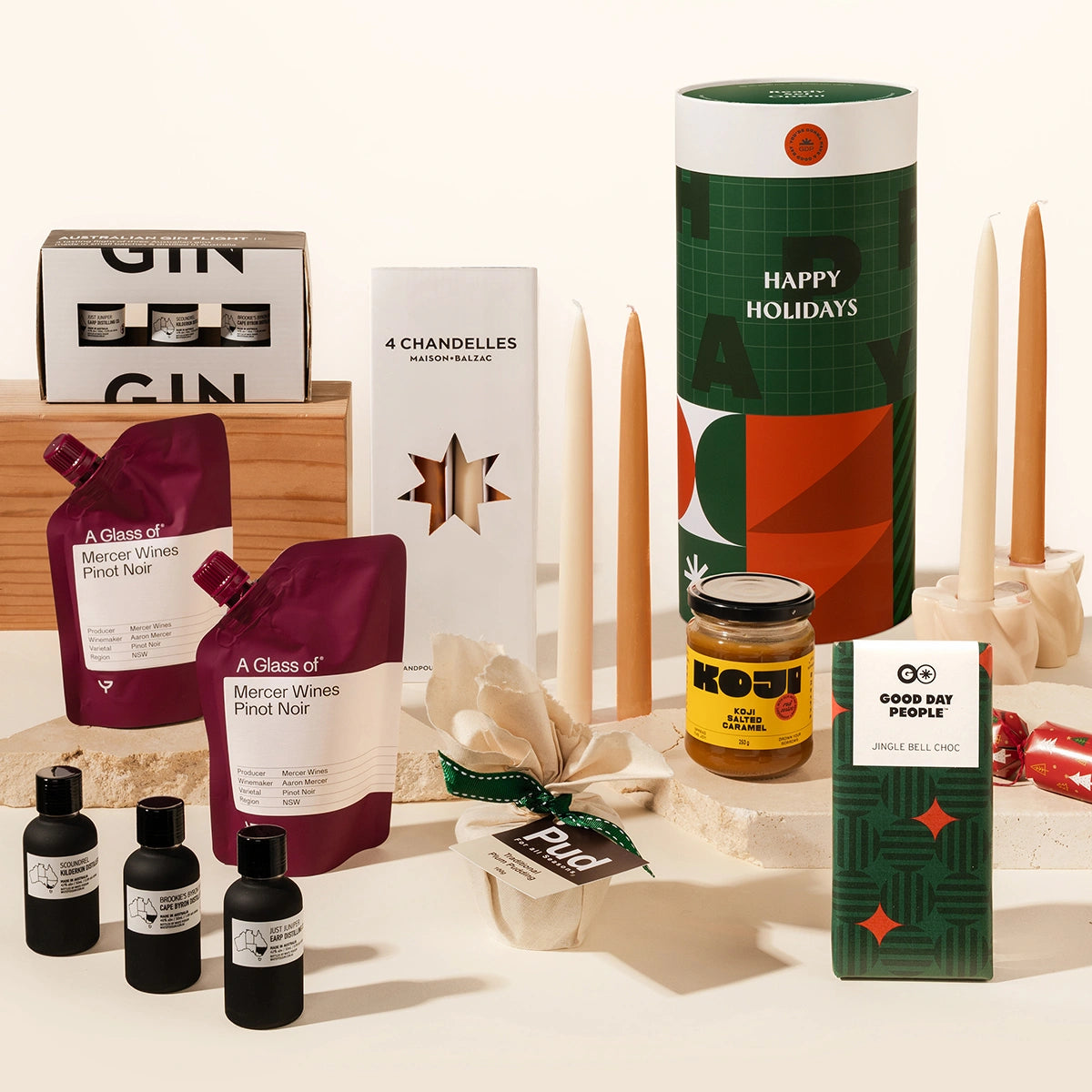 Luxury Christmas gift hamper with your choice of a gin or whisky tasting flight, 2 wine pouches by A Glass Of, KOji miso caramel, christmas pudding, 4 tapered candles by maison balzac and jingle bell chocolate (gingerbread choc).