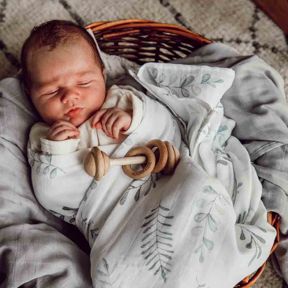 Baby Wrapped In Wild Fern Organic Muslin Swaddle