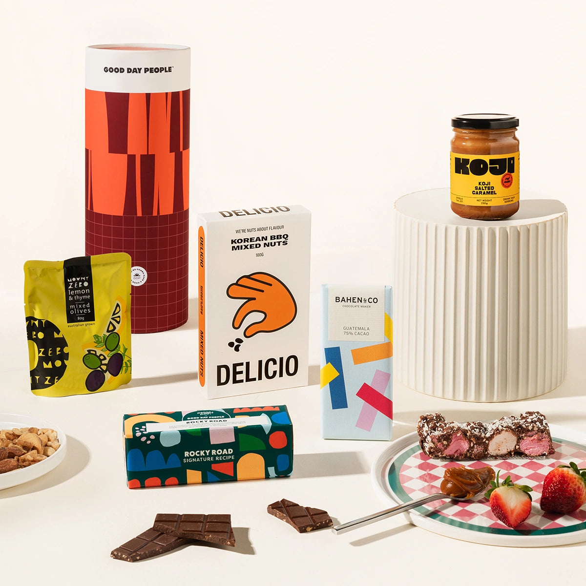 Gourmet gift hamper packaged in a fun canister. The hamper contains olives, Korean BBQ mixed nuts, organic chocolate, rocky road & miso caramel. 