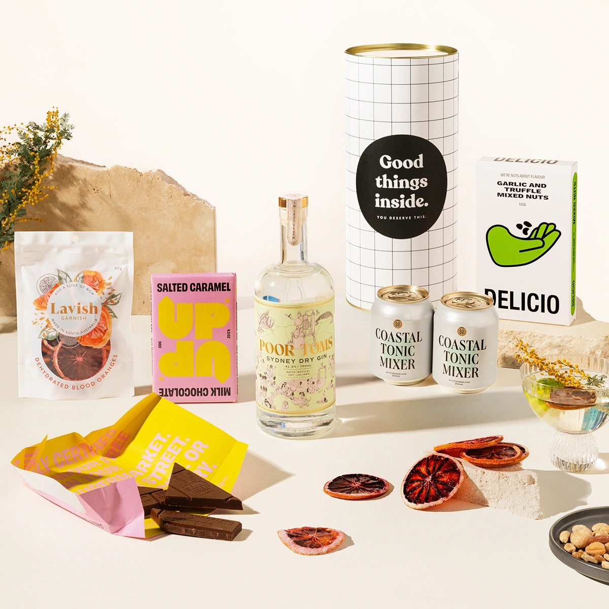 Gin Gift hamper with Poor Toms Sydney Dry Gin, 2 cans of Strangelove coastal tonic mixers, Up-Up chocolate, Lavish blood orange garnishes and Delicio garlic & truffle mixed nuts. Packaged in a fun gift canister. 