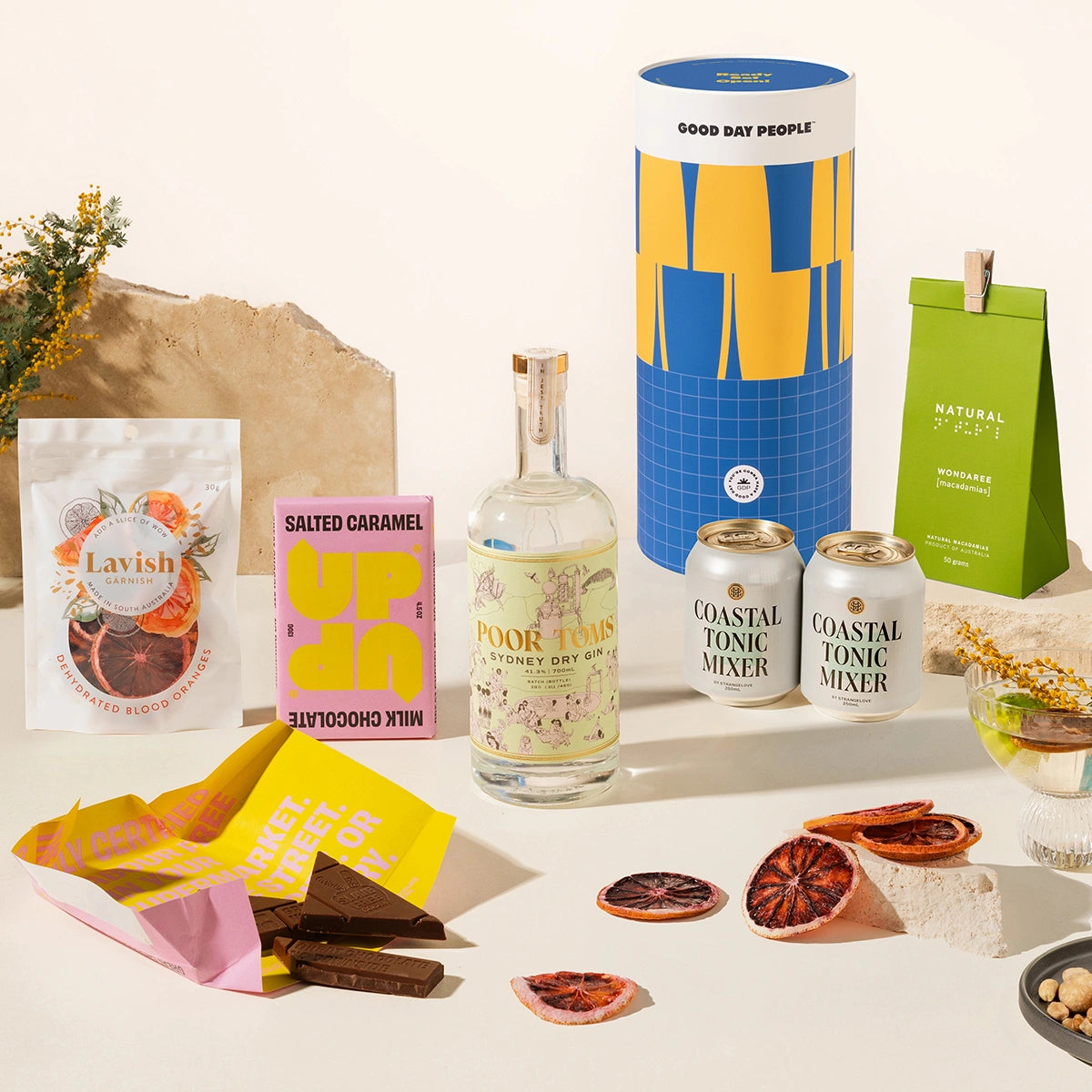 Gin Gift hamper with Poor Toms Sydney Dry Gin, 2 cans of Strangelove coastal tonic mixers, Up-Up chocolate, Lavish blood orange garnishes and Delicio garlic & truffle mixed nuts. Packaged in a fun gift canister. 