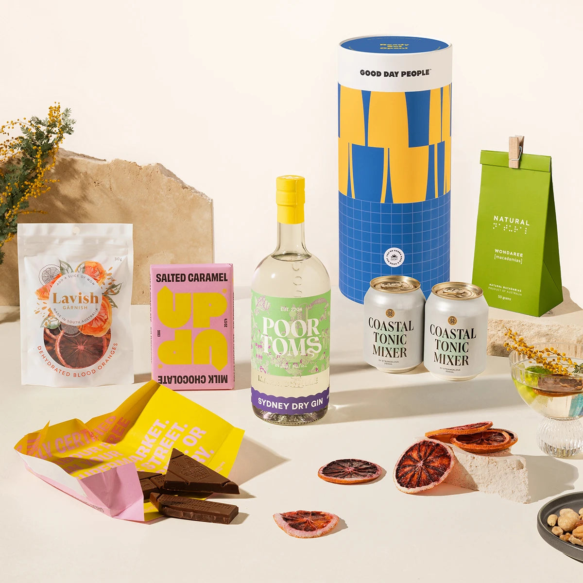 Gin Gift hamper with Poor Toms Sydney Dry Gin, 2 cans of Strangelove coastal tonic mixers, Up-Up chocolate, Lavish blood orange garnishes and Delicio garlic & truffle mixed nuts. Packaged in a fun gift canister. 