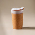 Cork-look tumbler with white lid on a white background