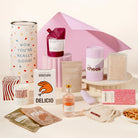 Pamper hamper with a vibrator sex toy, wine, mixed nutes, candle, face masks, lychee martini, chocolate, body scrub and body soak. Packaged in a designed canister. 