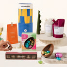 The Choccy Chloe Gift Hamper with assorted Easter-themed products including chocolates, wine, and a gift box on a white surface.