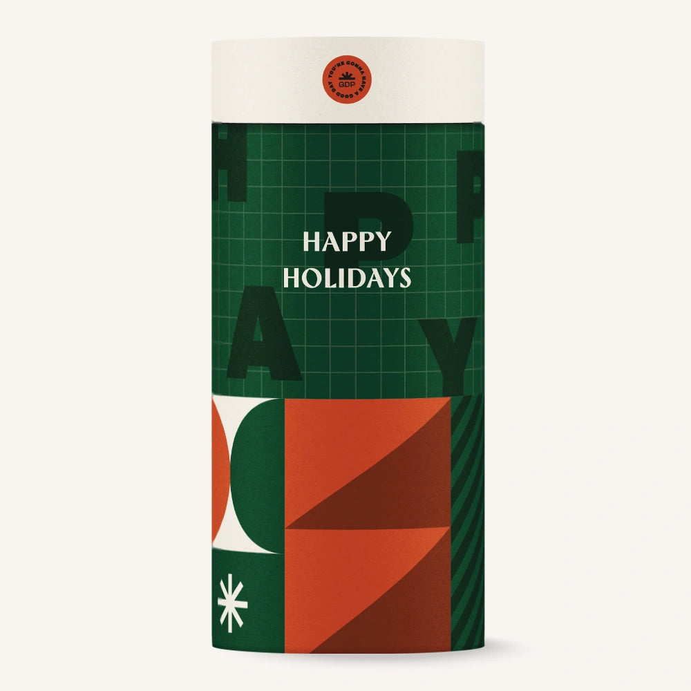 Cylindrical gift box with geometric design and 'Happy Holidays' text on a white background