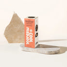 Box of Cool Medjool organic dark chocolate covered dates on a marble surface with a white background