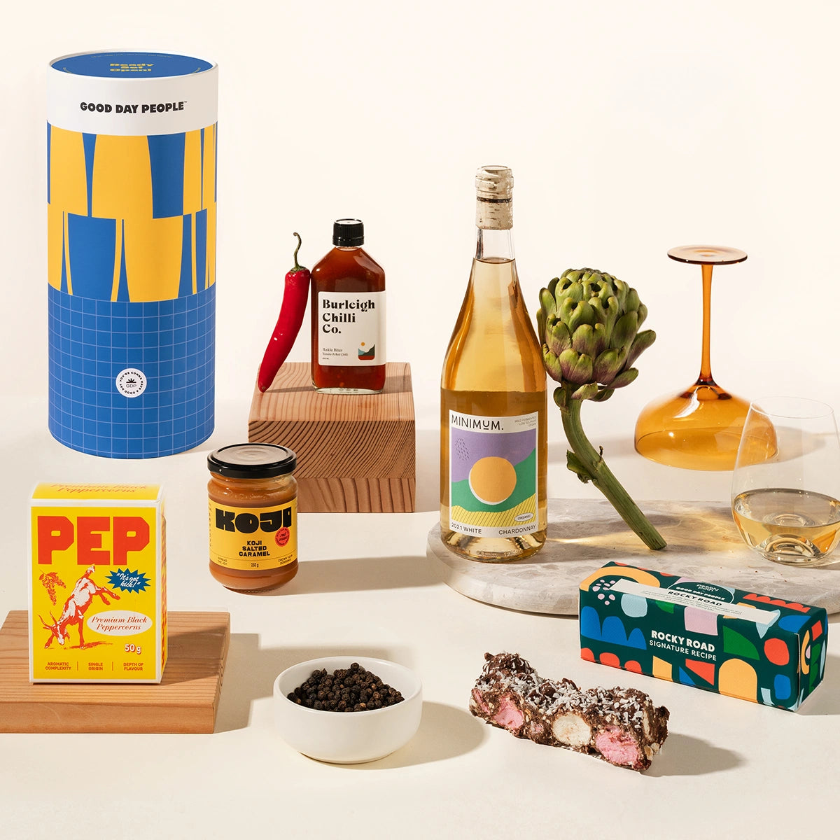 Gourmet Greg Gift Box with wine, chilli sauce, miso caramel, gourmet pepper and rocky road. Packaged in a design-forward canister.