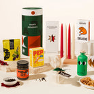 Luxurious Christmas Hamper with 4 tapered candles, korean mixed nuts, hojicha spread, greek olive oil, christmas pudding, gourmet pepper & mount zero olives. Packaged in an epic, designed canister. Trendy & Bougie Christmas gift.