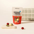 A stand-up pouch of House of Nom Mixed Feelings treats. It contains chocolate coated raspberry jellies, sour cherries and matcha almonds.