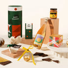 Gourmet Christmas gift set with a bottle of alcohol, chocolates, miso caramel, christmas pudding, gin bauble