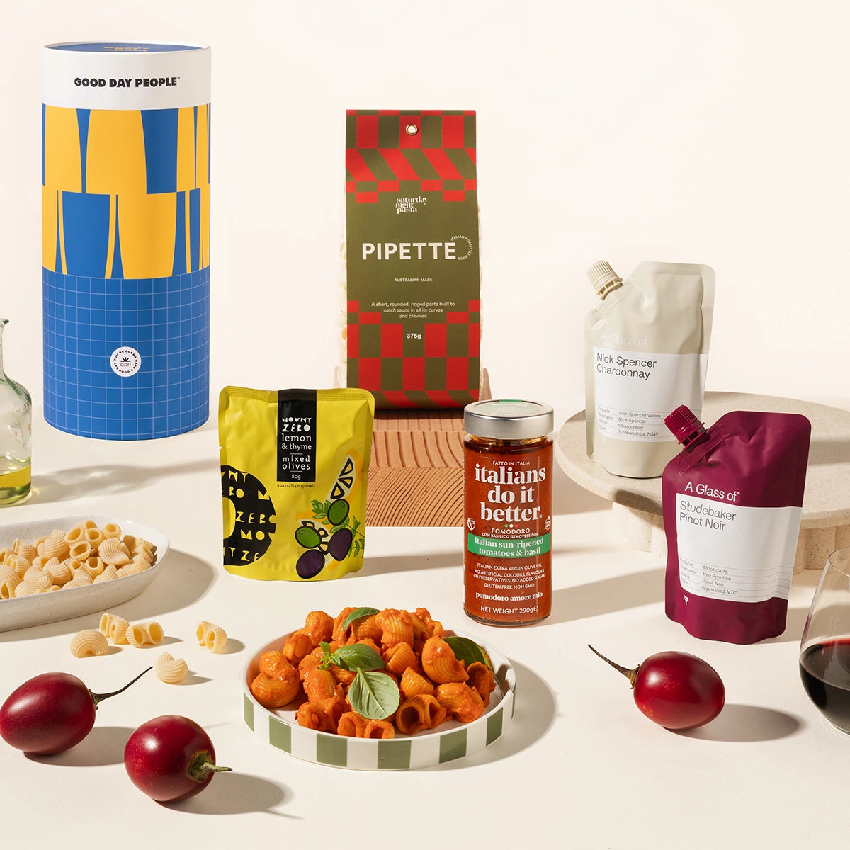 Assorted food hamper including pasta, wine, pasta sauce, olives in a beautifully designed canister. 