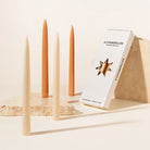 Maison Balzac set of 4 caramel and beige candles with a '4 Chandeliers' box on a neutral background