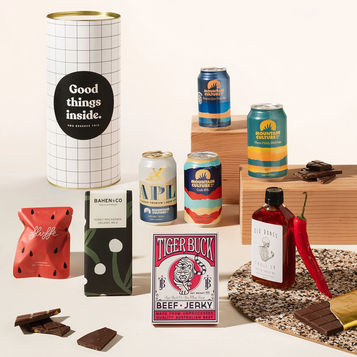 Craft beer hamper with 4 cans of Mountain Culture beer, tiger buck beef jerky, Old Bones chilli oil, organic chocolate and fairy floss. Packaged in a designed canister. 