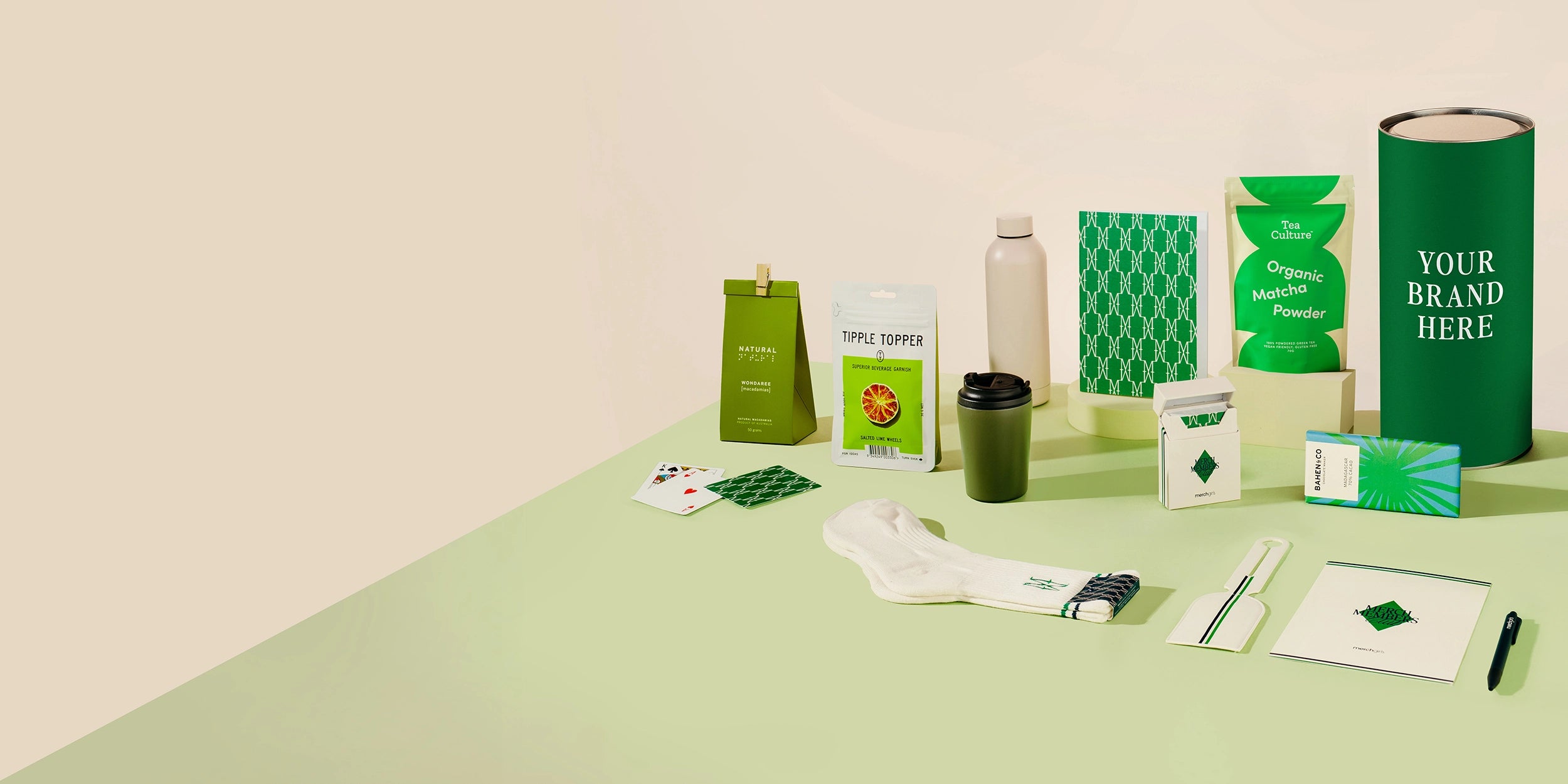 Collection of green branded products on a light beige background