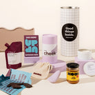 Pamper hamper with a Normal Cheek palm vibrator sex toy, chocolate, wine, miso caramel and candle. Packaged in a designed canister. 