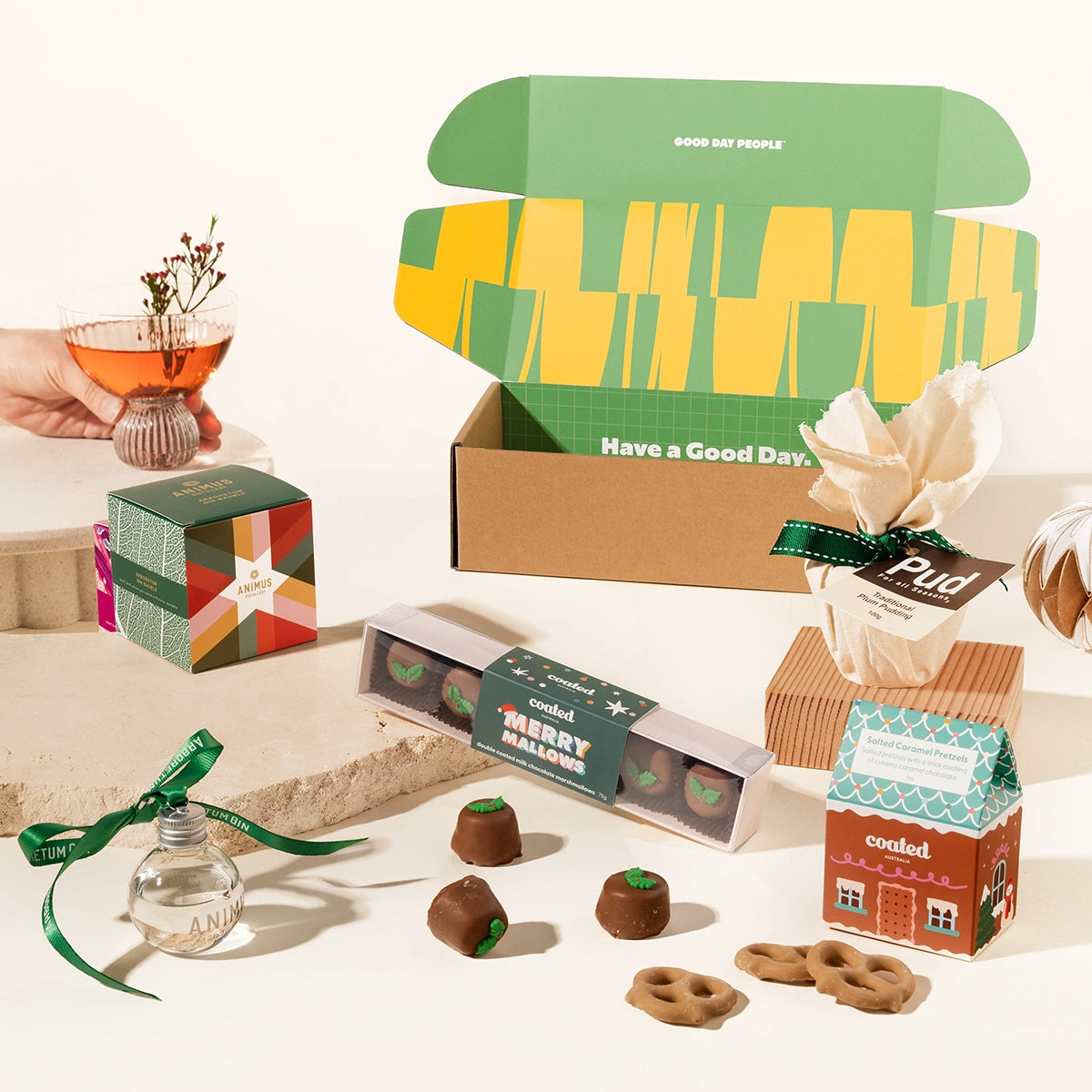 Christmas gift box with gin bauble, christmas pudding, salted caramel pretzels, and chocolate coated marshmallows