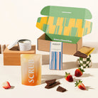 Pamper penny gift box with organic chocolate, a scented candle and body scrub