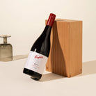 A bottle of Penfolds Max's Pinot Noir 2014 wine leaning against a timber block
