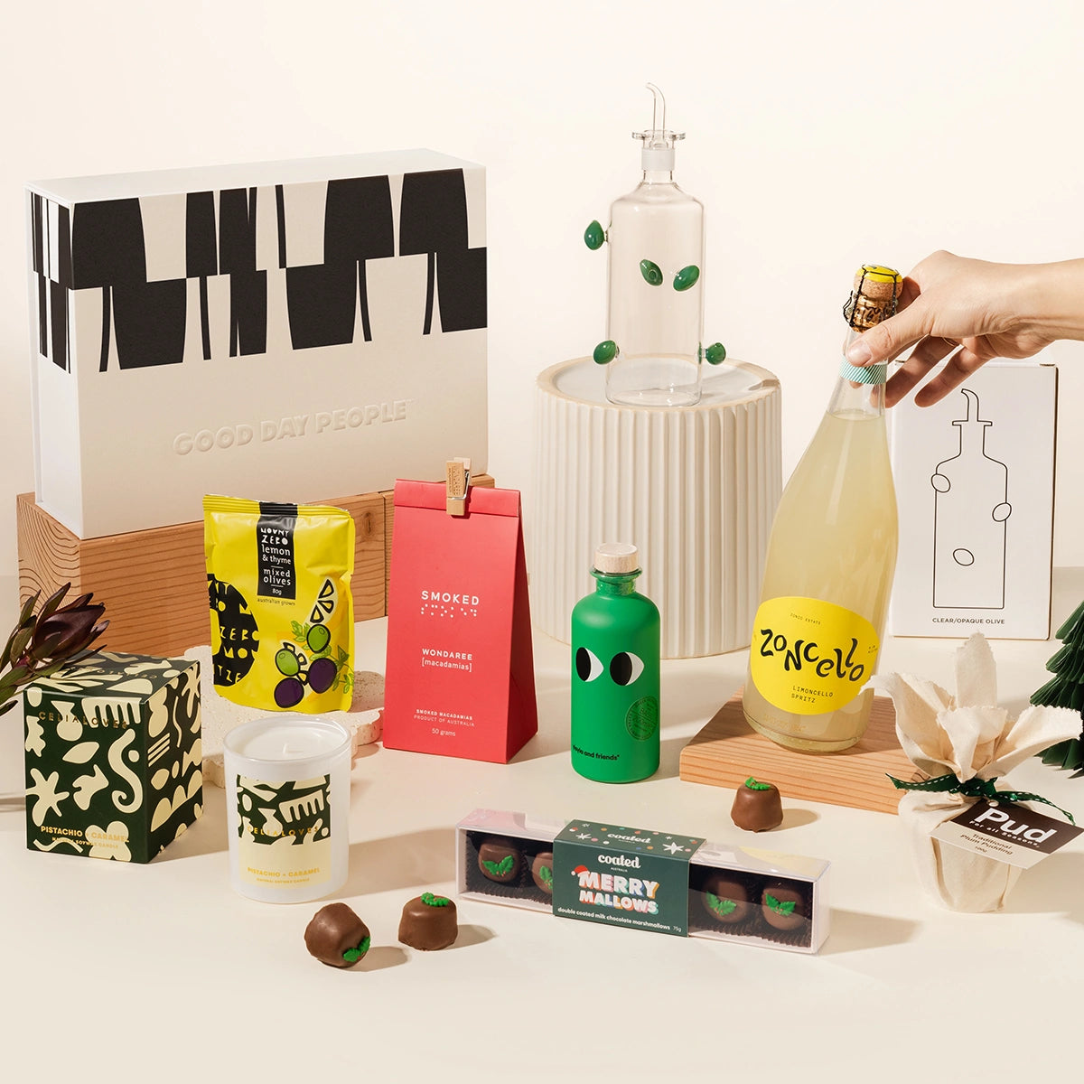 Luxury gift hamper with limoncello spritz, glass olive oil bottle from maison balzac, yia yia olive oil, wondaree macadamias, mount zero olives, celia loves candle, chocolate coated marshmallows and christmas pudding