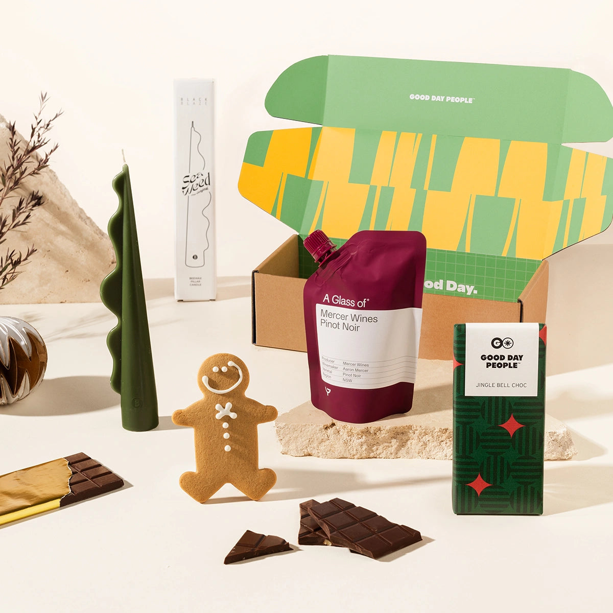 Christmas gift hamper including a gingerbread man, chocolate, a wine pouch  and a decorative candle