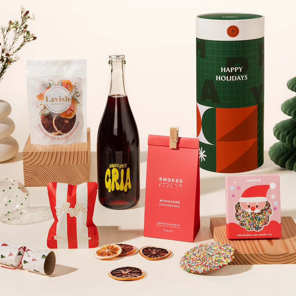 Christmas gift hamper with sangria spritz, blood orange garnishes, macadamias, chocolate and fairy floss. Delivered in a fun, luxe, designed canister. 