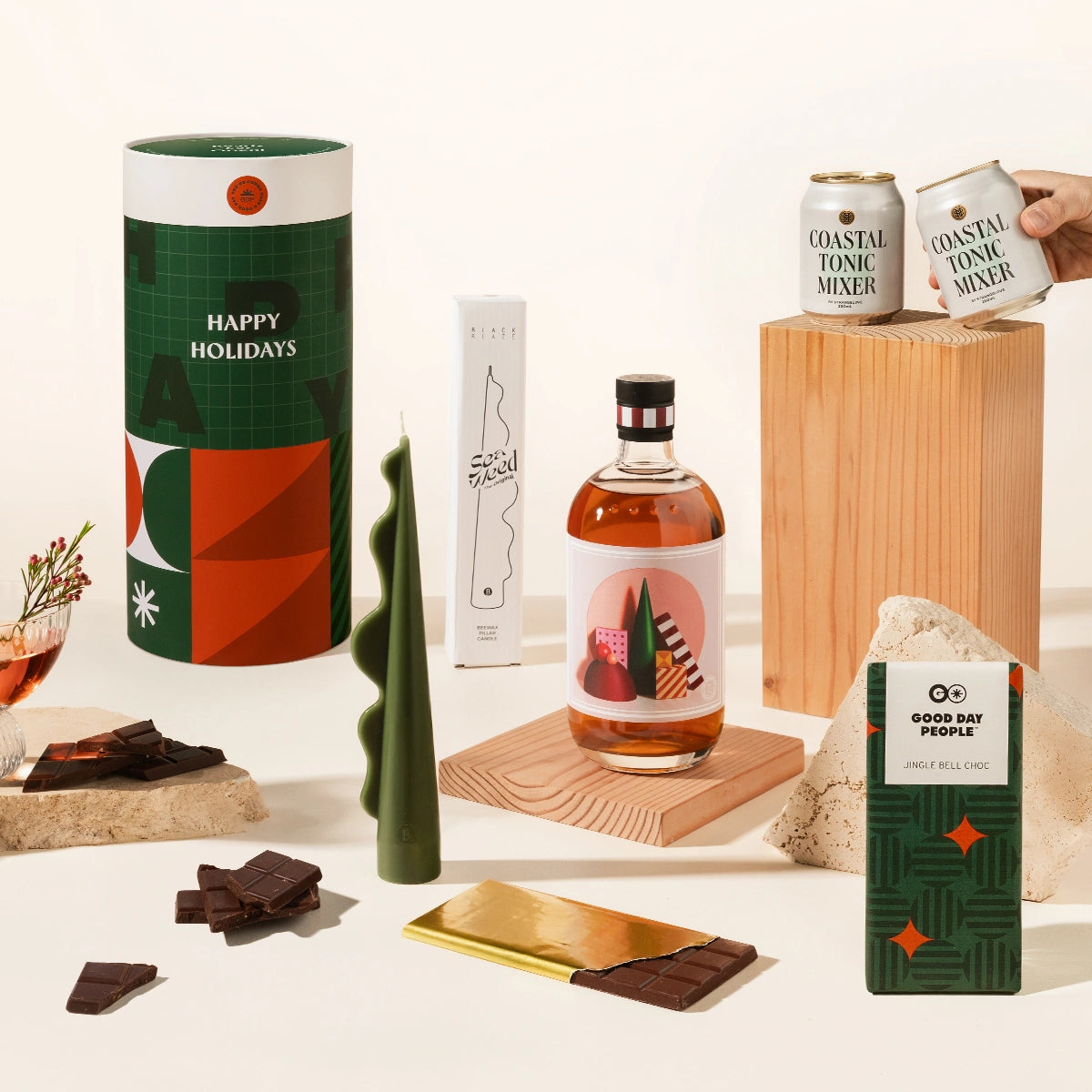 Gin and tonic inspired Christmas gift hamper, with Christmas gin from Four Pillars, 2 cans of Strangelove tonic, a sculptural pillar candle and gingerbread chocolate. Delivered in a fun, designed canister. 