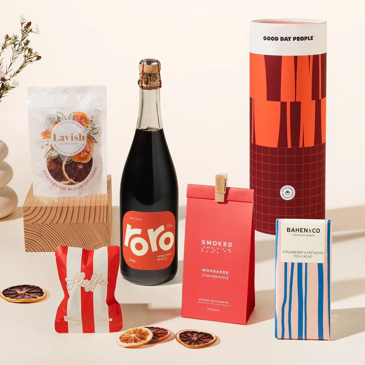 A spritzy gift hamper with Zonzo's Roro Aperitivo Spritz, macadamias, chocolate, fancy fairy floss and blood orange garnishes. Packaged in a designed canister for an extra bougie unboxing experience.