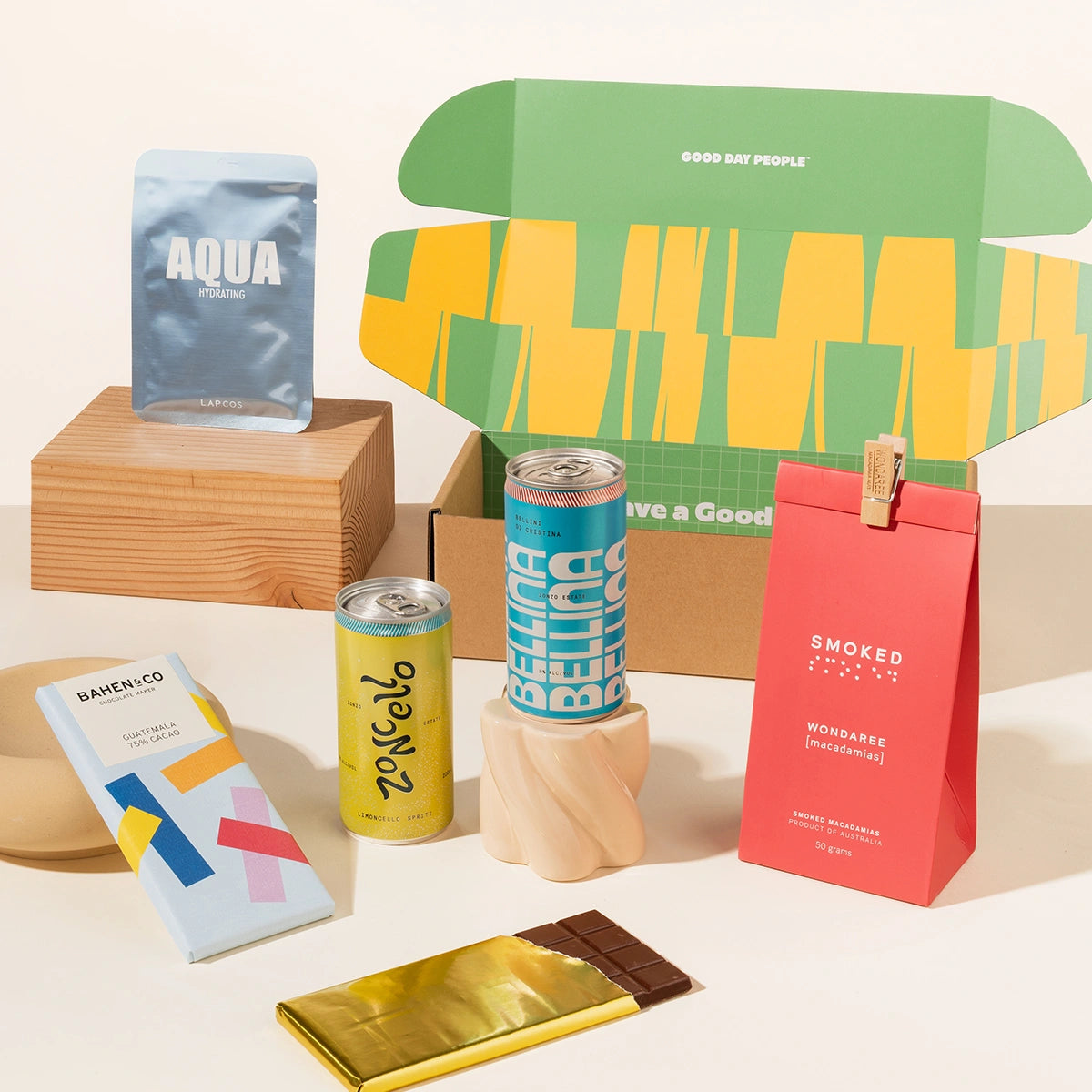 Summer gift pack including peach belini, limoncello spritz, chocolate, a face mask, and macadamias. 