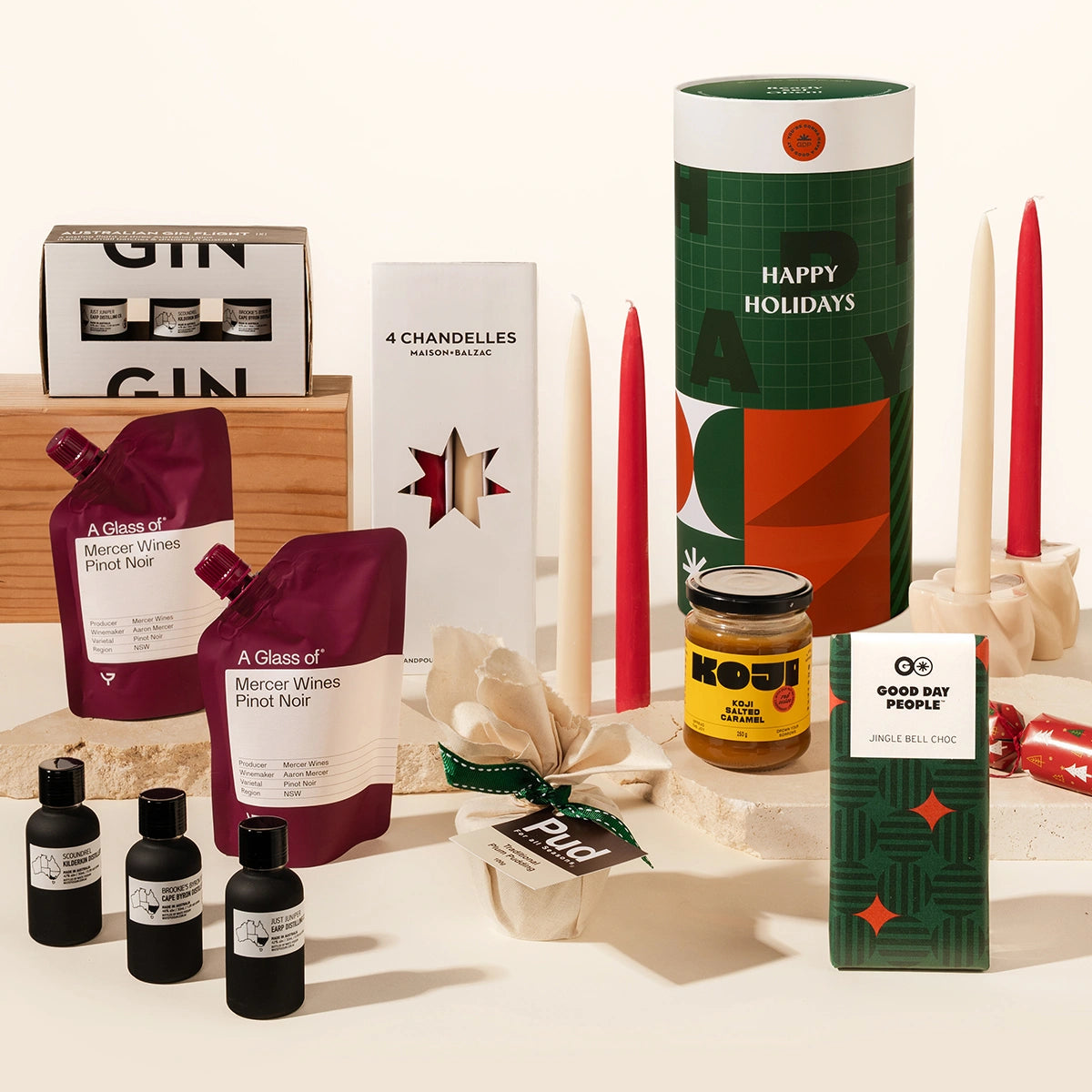 Luxury Christmas gift hamper with your choice of a gin or whisky tasting flight, 2 wine pouches by A Glass Of, KOji miso caramel, christmas pudding, 4 tapered candles by maison balzac and jingle bell chocolate (gingerbread choc). 