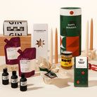 Luxury Christmas gift hamper with your choice of a gin or whisky tasting flight, 2 wine pouches by A Glass Of, KOji miso caramel, christmas pudding, 4 tapered candles by maison balzac and jingle bell chocolate (gingerbread choc). 