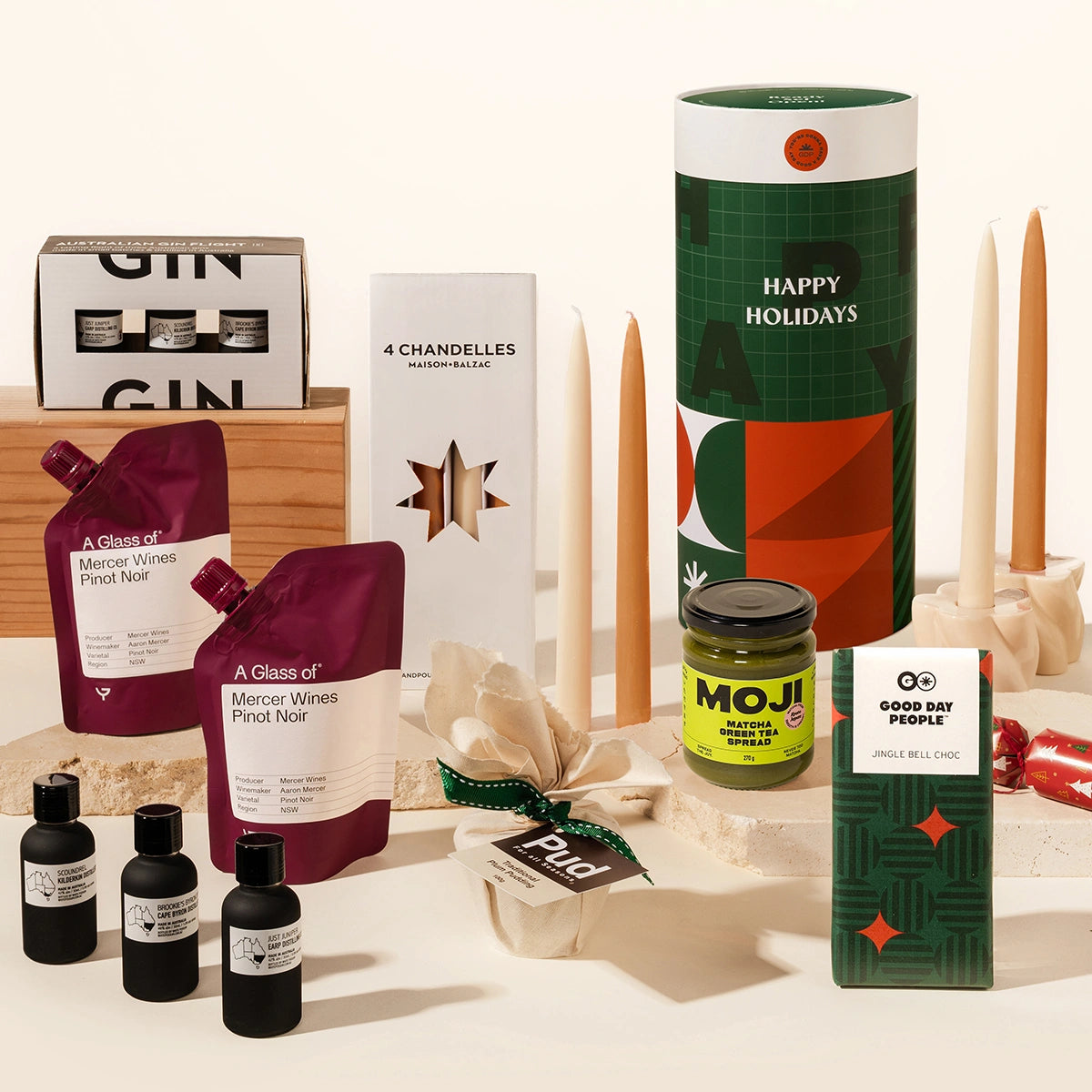 Luxury Christmas gift hamper with your choice of a gin or whisky tasting flight, 2 wine pouches by A Glass Of, KOji miso caramel, christmas pudding, 4 tapered candles by maison balzac and jingle bell chocolate (gingerbread choc). 