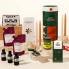 Luxury Christmas gift hamper with your choice of a gin or whisky tasting flight, 2 wine pouches by A Glass Of, KOji miso caramel, christmas pudding, 4 tapered candles by maison balzac and jingle bell chocolate (gingerbread choc). 