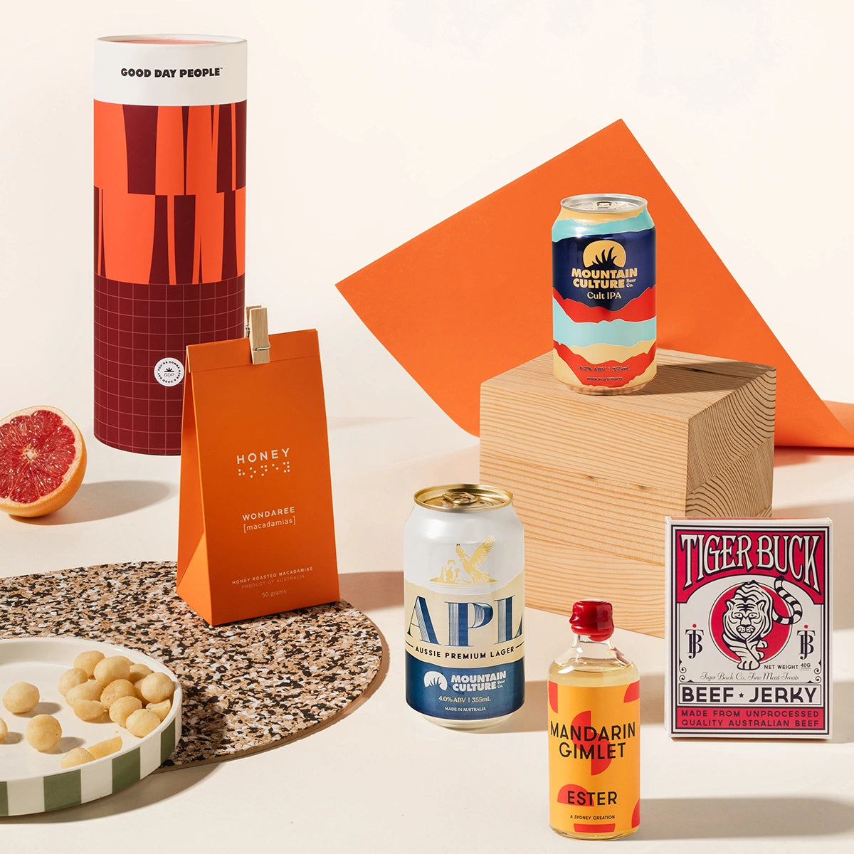 Craft beer hamper with 2 cans of Mountain Culture beer, Ester mandarin gimlet, tiger buck beef jerky, and macadamias. 