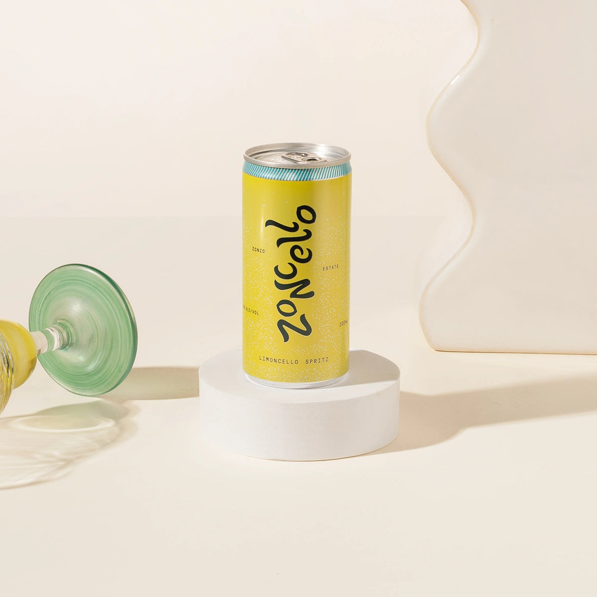 Yellow can of Zoncello lemoncello spritz on a white surface with a light background